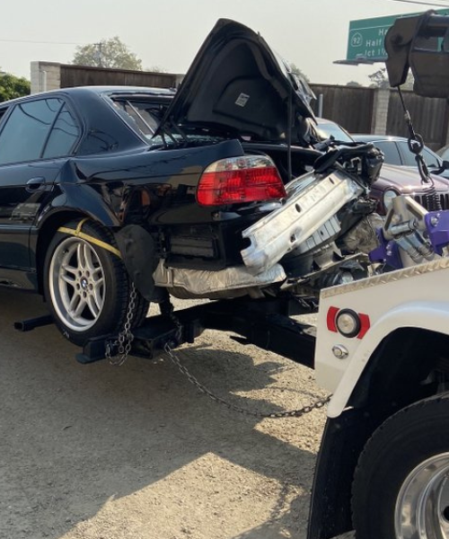 A car that is sitting on the back of a truck