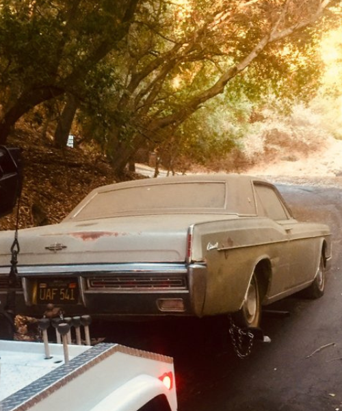 An old car parked on the side of the road